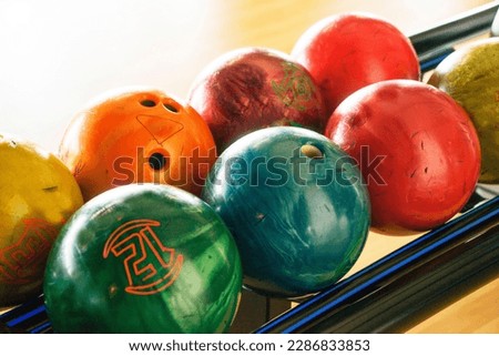 Stand with colorful bowling balls in club no people.