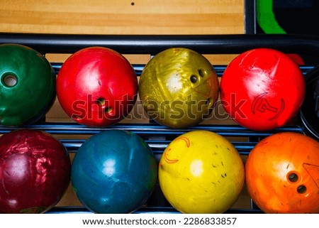 Stand with colorful bowling balls in club no people.