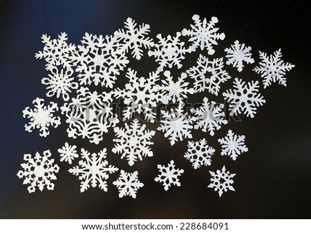 White paper snowflakes on dark background