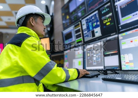 Engineer working at control room,Manager control system,Technician man monitoring program from a lot of monitor Royalty-Free Stock Photo #2286845647