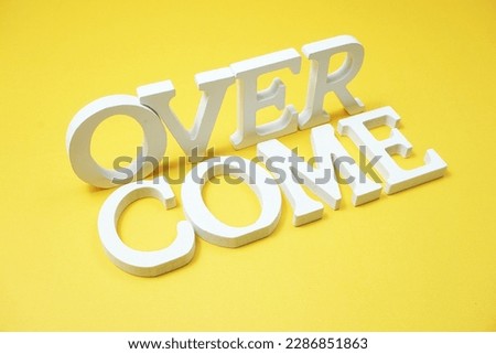 Over Come alphabet letters on yellow background
