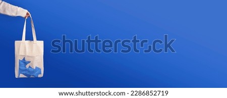 Panoramic shot of a bag on a dark blue background. Empty space in the photo. 