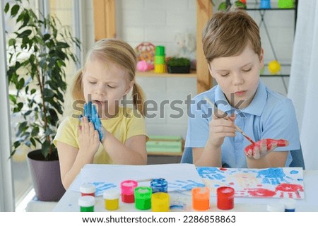 Children paint fingers drawing baby painting hand therapy children art play. Kids have fun and create picture. Palms of different colors. Sensory development and experiences, themed activities