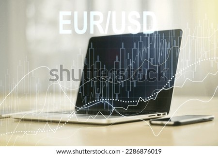 Double exposure of creative EURO USD forex chart hologram on laptop background. Banking and investing concept