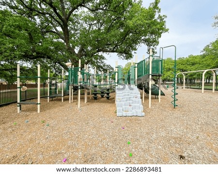 Mulch ground playground with step climbing and colorful plastic eggs for kids Easter egg hunt activity near Dallas, Texas, America. Seasonal children and family holiday traditional activities