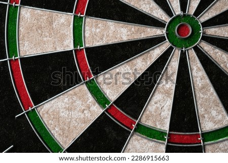 New classic professional sisal dart board on black wooden background. Close up Royalty-Free Stock Photo #2286915663