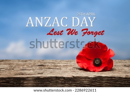 Poppy pin for Anzac Day. Poppy flower on old beautiful high grain, detailed wood on background of blue sky. Anzac Day Lest We Forget. Royalty-Free Stock Photo #2286922611