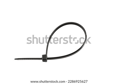 Black plastic cable ties isolated on white background. plastic wire ties close-up. Royalty-Free Stock Photo #2286925627