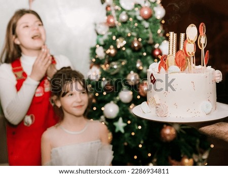 girl is going to blow out the candles on the birthday cake

