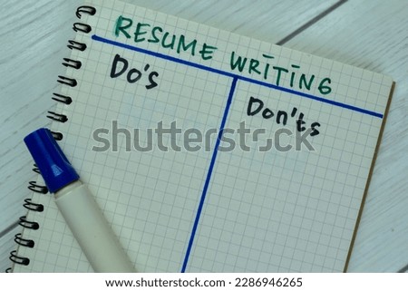 Concept of Resume Writing and Do's or Don'ts write on book isolated on Wooden Table.