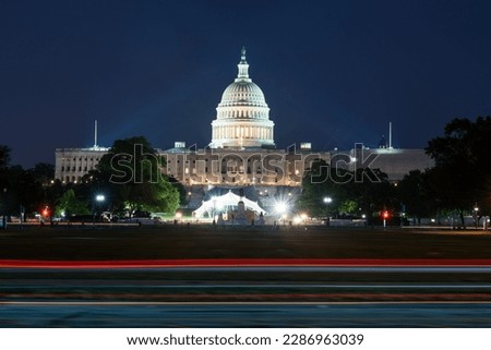 The United States Capitol building with the dome lit up at night, Washington DC, night time cityscape