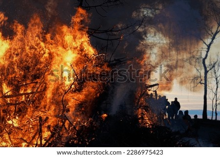 Fire In Germany. Holy Saturday, Dark Easter Night And People Silhouettes.