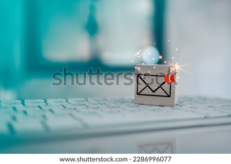 Wood cube block with envelope and notifications symbol icon for check e-mail on keyboard. Checking email. Direct marketing, online message, E-mail, electronic mail,communication concept. Royalty-Free Stock Photo #2286996077