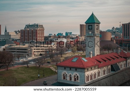 Photo of a train station and Baltimore skyline. 