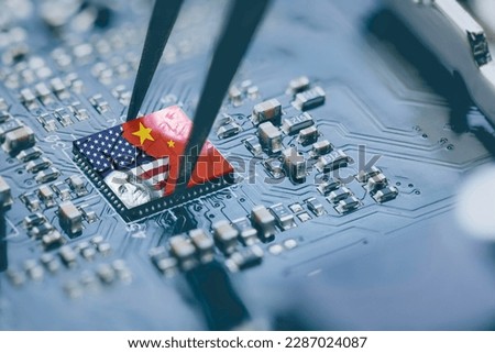 Flag of USA and China on a processor, CPU or GPU microchip on a motherboard. US companies have become the latest collateral damage in US - China tech war. US limits, restricts AI chips sales to China. Royalty-Free Stock Photo #2287024087