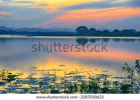Beautiful view of Waduk Bunder or Water Dam Bunder in Gresik, East Java, Indonesia during sunrise and cloudy wheater. Royalty-Free Stock Photo #2287030621