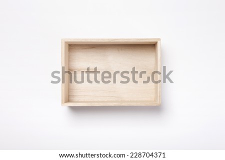 A empty wooden box isolated white, top view. Royalty-Free Stock Photo #228704371