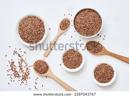 flat lay top view flaxseed or linseed in spoon and bowl isolated on white background. flat lay top view flaxseed or linseed in spoon and bowl isolated on white food background. flaxseed or linseed Royalty-Free Stock Photo #2287043767