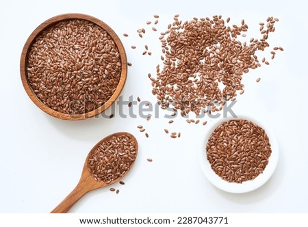 flat lay top view flaxseed or linseed in spoon and bowl isolated on white background. flat lay top view flaxseed or linseed in spoon and bowl isolated on white food background. flaxseed or linseed Royalty-Free Stock Photo #2287043771