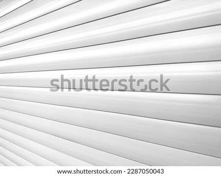Roller shutter gate. Metal roller garage door as background. Automatic electric roll-up garage gate. Garage with white rolling gates.	
 Royalty-Free Stock Photo #2287050043