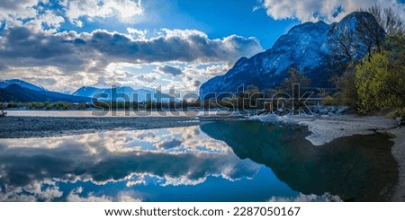 The Alps Northern Range Mountains skyline, Inn River and pebble beach, cloudscape, and water reflections in Tyrol, western Austria