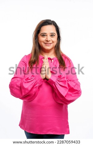 Indian woman giving namaste or welcome gesture on white background
