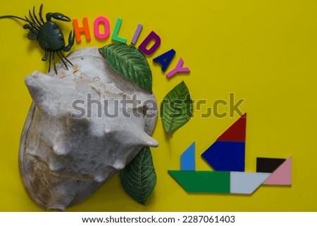 Holiday letters with seashells cassis cornuta, crab, leaves and boat made from tangram pieces. Beach holiday concept on yellow background
