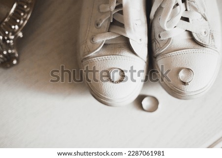 Beautiful toned picture with wedding rings and wedding shoes