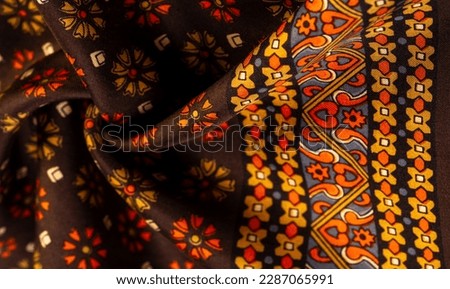 silk fabric of brown color with red and yellow colors, dense fabric, double-sided based on triacetate fibers. Background, Pattern Decor