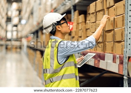Portrait asian engineer man shipping order detail check goods and supplies on shelves with goods background inventory in factory warehouse.logistic industry and business export