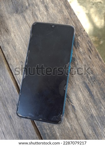 a cracked smartphone on the screen and looks messy