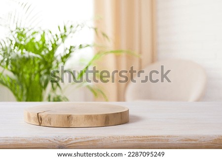Wooden podium on table in living room interior with space