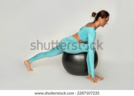 woman is on a fitball and performs exercises for the abdomen and other parts of the body. isolated on white background .fitball for training concept