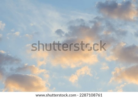 Background of blue sky with golden clouds at sunset