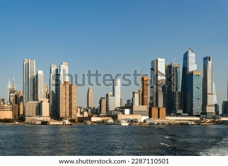 New York office skyscrapers under blue sky at daylight, waterfront and financial corporation. NY cityscape, Manhattan business buildings in summer