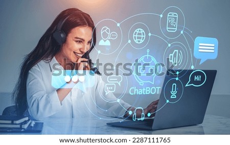 Portrait of smiling young businesswoman in headphones using laptop in office with double exposure of immersive chatbot interface. Concept of artificial intelligence Royalty-Free Stock Photo #2287111765