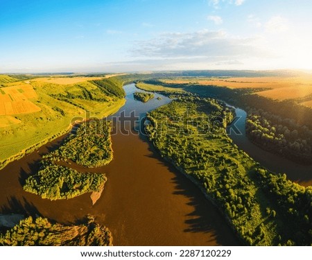 Landscape with a picturesque river flowing through green meadows. Location place Dniester canyon national park, Ukraine, Europe. Aerial photography, top view drone shot. Discover the beauty of earth.