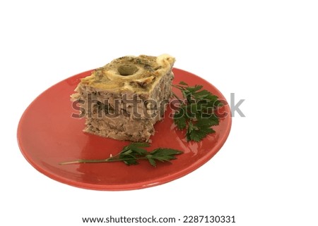 Homemade cod pie with palm heart and olive on a ceramic plate isolated on a white background and copy space. Torta capixaba