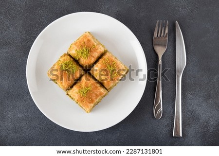Pistachio Turkish baklava on a white plate.Traditional delicious Turkish baklava,top view Royalty-Free Stock Photo #2287131801