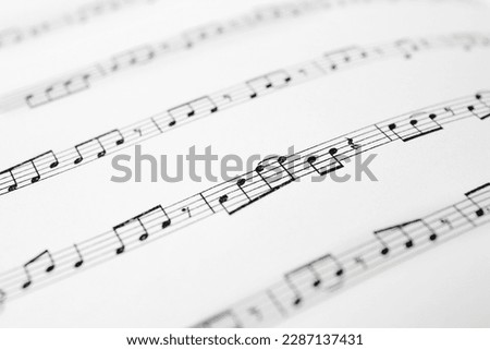 Sheet of paper with music notes as background, closeup