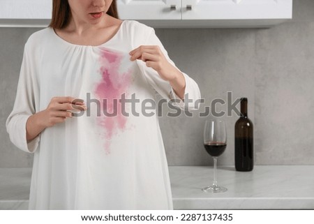 Woman with wine stain on her clothes indoors, closeup. Space for text Royalty-Free Stock Photo #2287137435