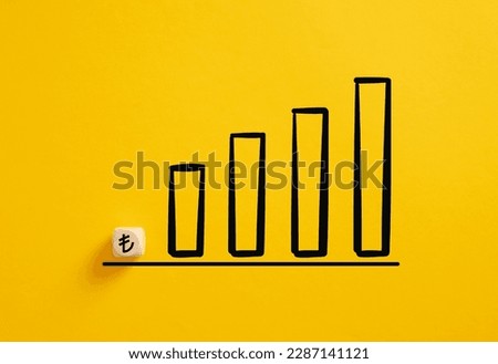 Turkish Lira currency rate growth concept. Business profit increase.. Lira symbol on a wooden cube with an ascending graph.