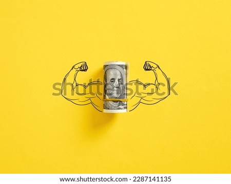 Bunch of United States dollar money with flexing muscle biceps on yellow background. Strong or highest currency concept. Royalty-Free Stock Photo #2287141135
