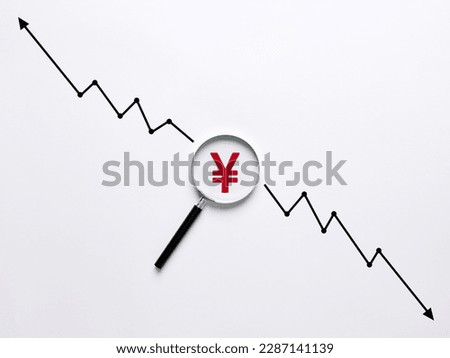 Analyzing the dynamics of the growth and fall of the Yen currency. Currency Exchange Rate concept. Yen symbol under the magnifying glass with rising and declining graph arrows. Royalty-Free Stock Photo #2287141139