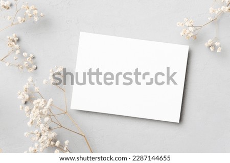 Wedding invitation card mockup with dry gypsophila, blank card with botanical decoration
