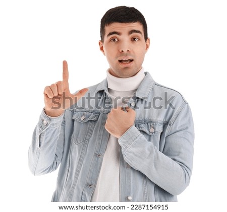 Young man showing loser gesture on white background