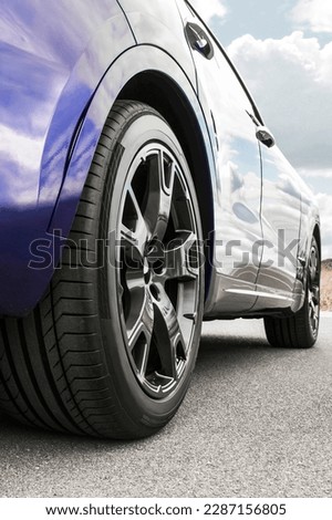 Car on sky background. Car wheels close up on a background of asphalt. Car tires. Car wheel close-up. for advertising