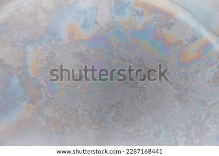 abstract metallic background, rainbow color on metal, interference of light waves in an oxide film