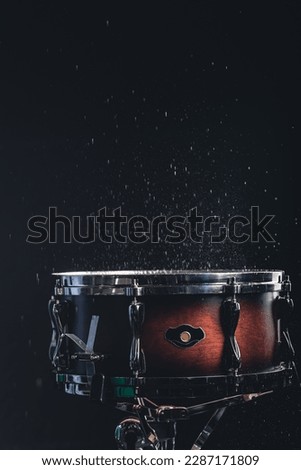 Beautiful snare drum on a black background, close up.