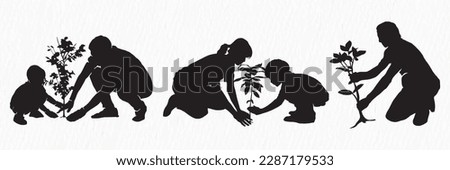 A silhouette of a family planting a tree